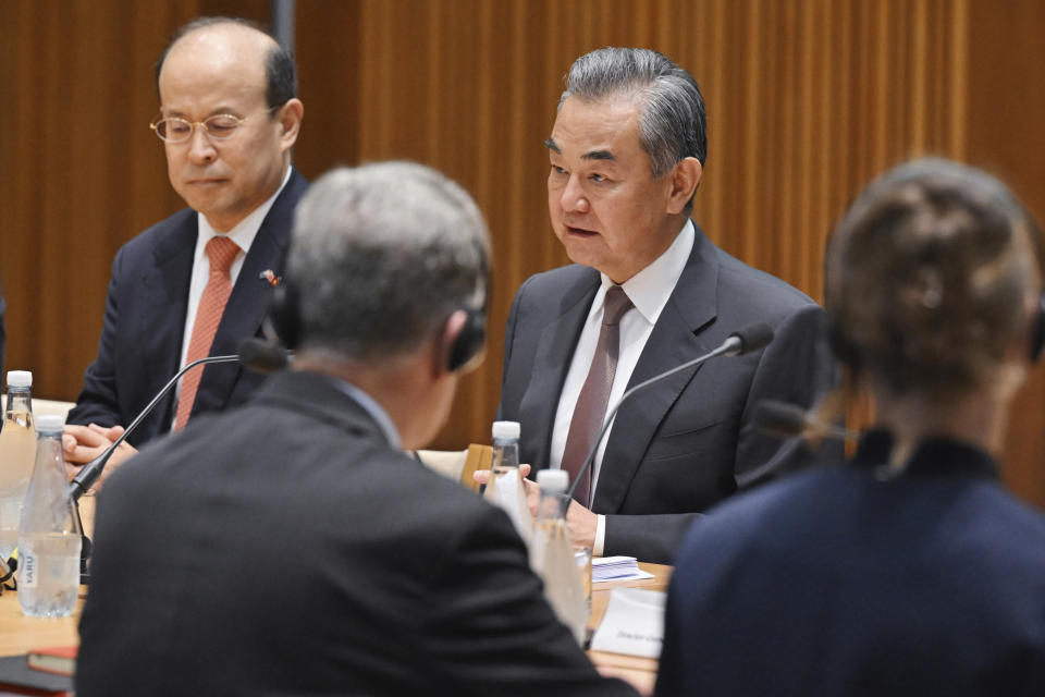 China's Foreign Minister Wang Yi, rear right, attends a meeting with Australia's Minister for Foreign Affairs Penny Wong, unseen, at Parliament House in Canberra, Wednesday, March 20, 2024. Wang met his counterpart as part of a high-ranking diplomatic tour of Australia and New Zealand this week. (Mick Tsikas/AAP Image via AP)