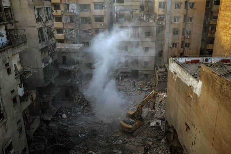 Lebanese Civil defense personnel work at the site that was targeted by Israeli air raids in central Beirut. At least 22 people were killed and 117 others were wounded, Lebanese health ministry said, in what appeared the deadliest attack in the Lebanese capital in more than a year of fighting between Israel and Hezbollah. Marwan Naamani/dpa