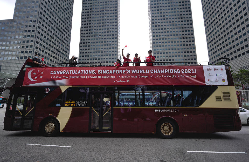 Top Singapore athletes Loh Kean Yew, Shayna Ng, Aloysius Yapp and Yip Pin Xiu during their celebratory open-top bus parade. (PHOTO: Sport Singapore)