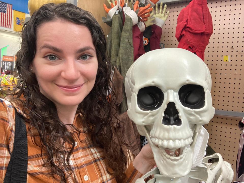 Insider reporter Talia Lakritz takes a selfie with a Halloween skeleton at Walmart.