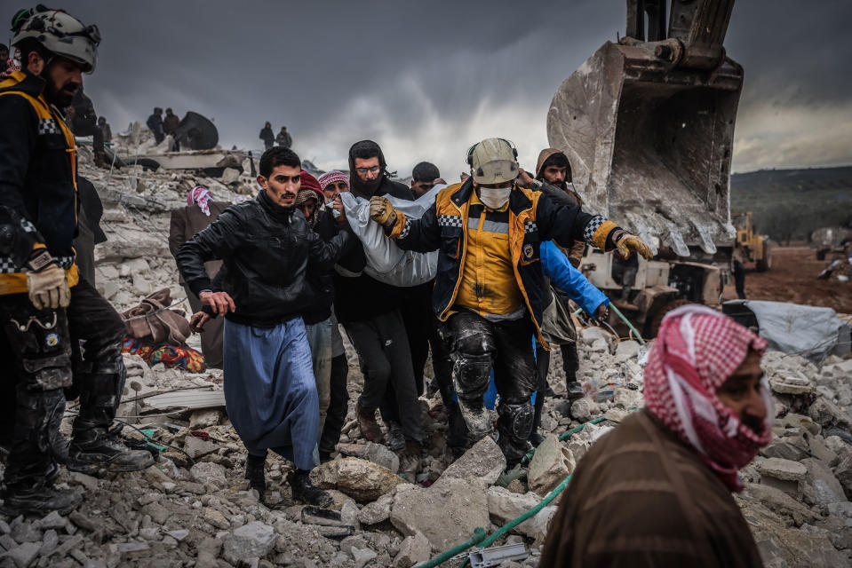 Syrian civilians and members of the White Helmets conduct search and rescue operations in the rubble of a collapsed building in Syria.<span class="copyright">Anas Alkharboutli—picture alliance/Getty Images</span>