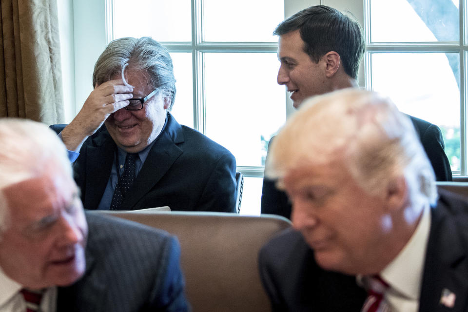 White House Senior Advisers Steve Bannon and Jared Kushner talk behind President Donald Trump and Secretary of State Rex Tillerson during a Cabinet meeting, Monday, June 12, 2017, in the Cabinet Room of the White House in Washington. (AP Photo/Andrew Harnik)