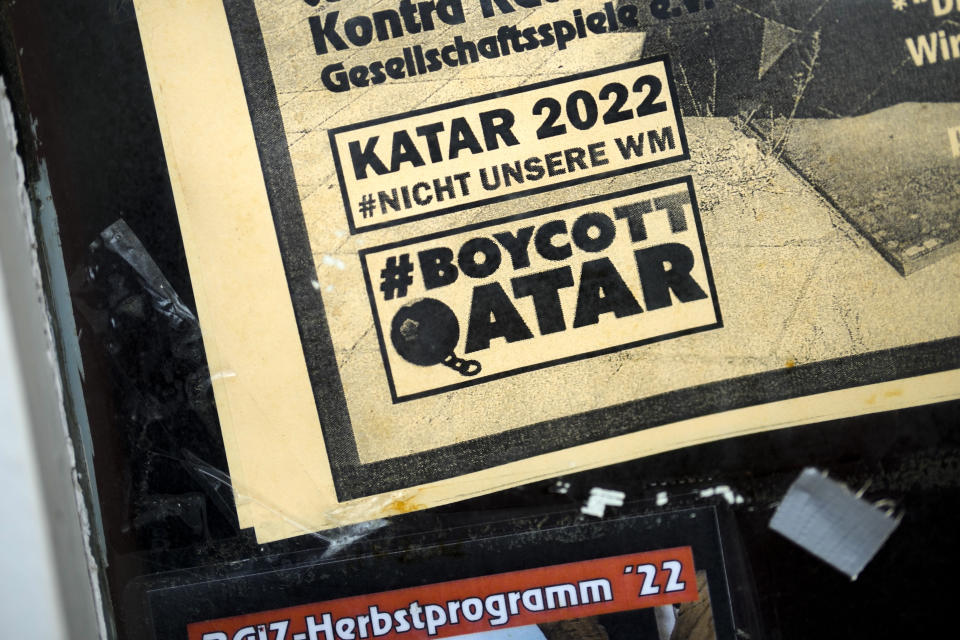 The slogans "Qatar 2022 not our World Cup" and "Boycott Qatar" are written on a flyer on the entrance door of the pub 'Baiz' in Berlin, Germany, Friday, Nov. 18, 2022. Normally when the World Cup comes around, Germans proudly fly their country’s flag and enthusiastically back their team. Not this time. People boycotting the tournament and many fans say they won't watch in protest against human rights abuses in Qatar. (AP Photo/Markus Schreiber)