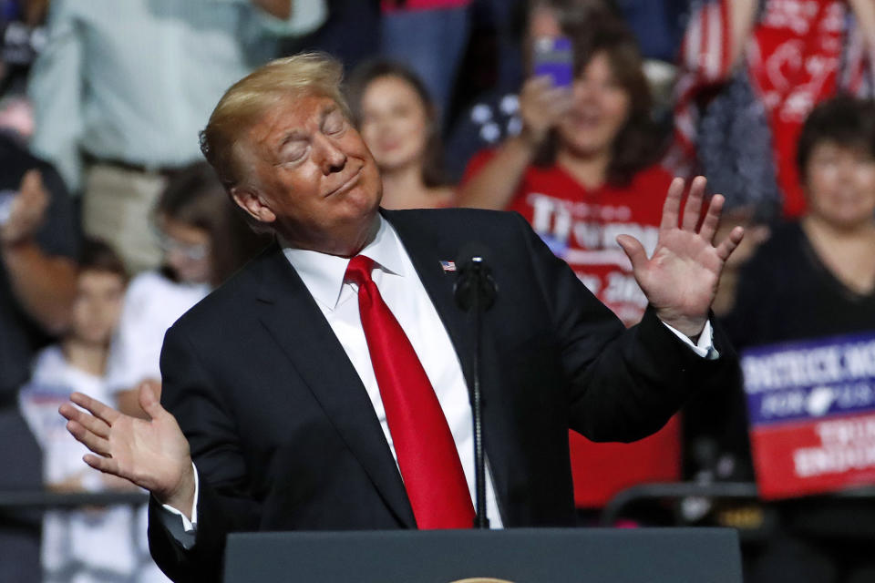 President Donald Trump reacts to the playing of West Virginia's state song as he takes the stage during a rally in Wheeling, W.Va., Saturday, Sept. 29, 2018. (AP Photo/Gene J. Puskar)