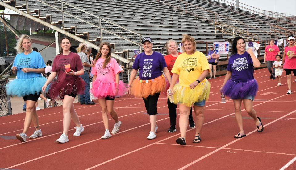 Participants dressed in tutus circle the track at Erhard Field during the Relay for Life of Southern Bastrop County.