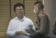 Pro-democracy activist and human rights lawyer Arnon Nampha talks to police at a police station, Friday, Aug, 7, 2020, in Bangkok, Thailand. The government cracked down on Friday with the arrests of some high profile members of the pro-democracy movement. Among them was Arnon, who was arrested on charges of sedition and defying an emergency decree the government instituted months ago to try to control the spread of the coronavirus. (AP Photo/Sakchai Lalit)