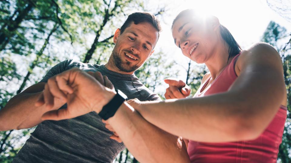 Man and woman looking at sports watches