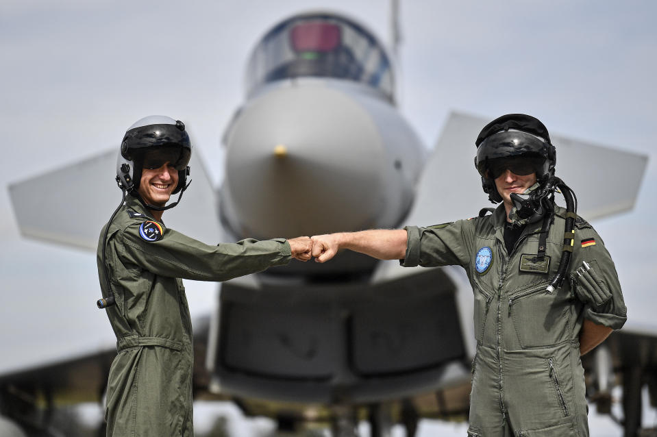 A pilot from Israel, left, and a pilot from Germany, right, pose in front of an Eurofighter at the airbase in Noervenich, Germany, Thursday, Aug. 20, 2020. Pilots from Israel and Germany will fly together the next two weeks during the first joint military Air Force exercises between the two nations in Germany. (AP Photo/Martin Meissner)