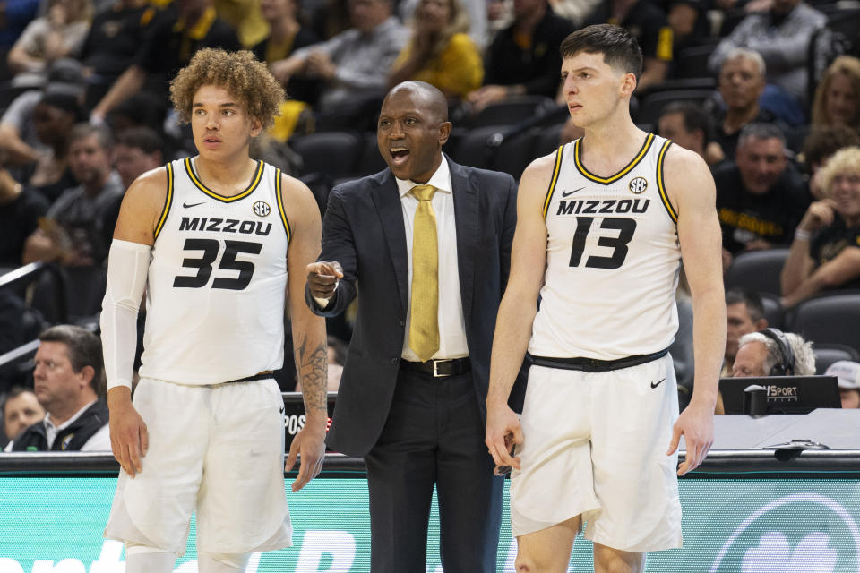 Missouri head coach Dennis Gates, center, talks to his team as he stands between Jesus Carralero Martin, right, and Noah Carter, left, during the first half of an NCAA college basketball game against Arkansas-Pine Bluff Monday, Nov. 6, 2023, in Columbia, Mo. (AP Photo/L.G. Patterson)
