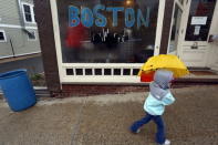 A child with an umbrella passes by a window painted with "Boston" near the Boston Marathon start line in Hopkinton, Massachusetts, April 20, 2015. . REUTERS/Dominick Reuter