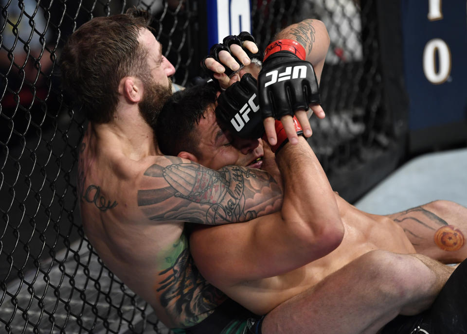 RALEIGH, NORTH CAROLINA - JANUARY 25:  (L-R) Michael Chiesa attempts to secure a choke submission against Rafael Dos Anjos of Brazil in their welterweight fight during the UFC Fight Night event at PNC Arena on January 25, 2020 in Raleigh, North Carolina. (Photo by Jeff Bottari/Zuffa LLC via Getty Images)