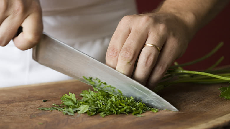 Person chopping fresh herbs