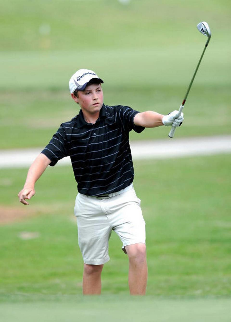 East Chapel Hill’s Ben Griffin raises his golf club into the air signaling that his chip onto No. 18 was in the hole during the second playoff to capture the NCHSAA 4A state boys golf championship onTuesday, May 10, 2011 at Pinehurst No. 6 Golf Course.