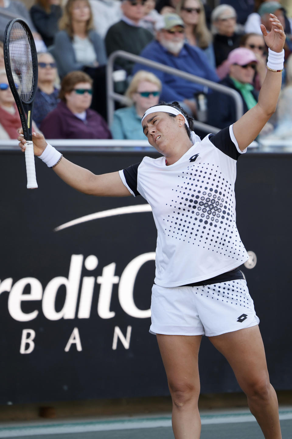 Ons Jabeur, of Tunisia, reacts after a bad shot against Belinda Bencic of Switzerland during the finals at the Charleston Open tennis tournament in Charleston, S.C., Sunday, April 10, 2022. (AP Photo/Mic Smith)