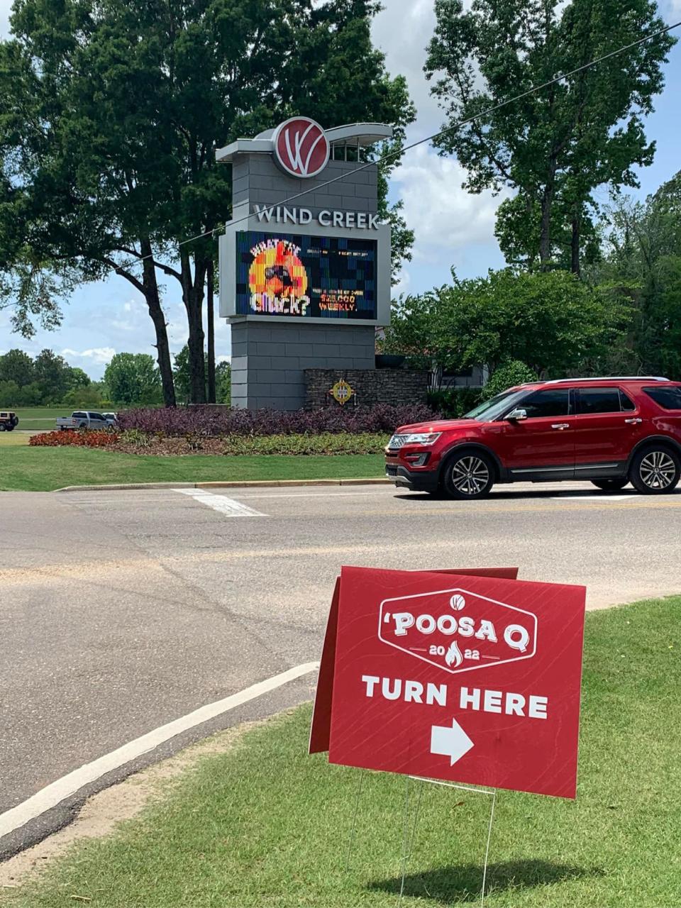 A sign points the way to 'Poosa Q at Wind Creek Montgomery.