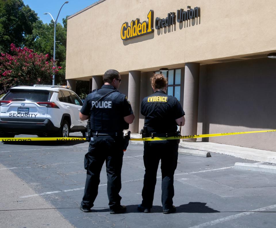 A Stockton Police investigate a homicide scene outside of the Golden 1 Credit Union at Sherwood Mall in Stockton. Before 11 a.m. police received a report of a shooting outside of the credit union. Officers located a man who had been shot and medics declared him dead at the scene.