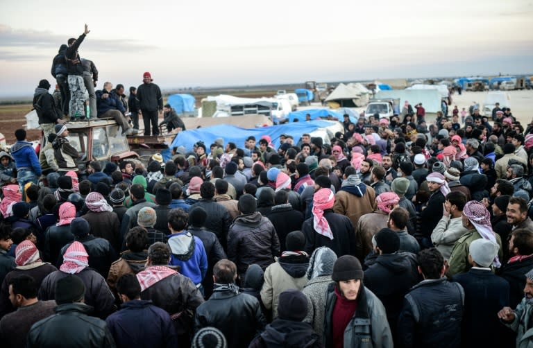 Syrians fleeing the northern embattled city of Aleppo wait on February 5, 2016 in Bab-Al Salama, northern Syria, near a Turkish crossing gate