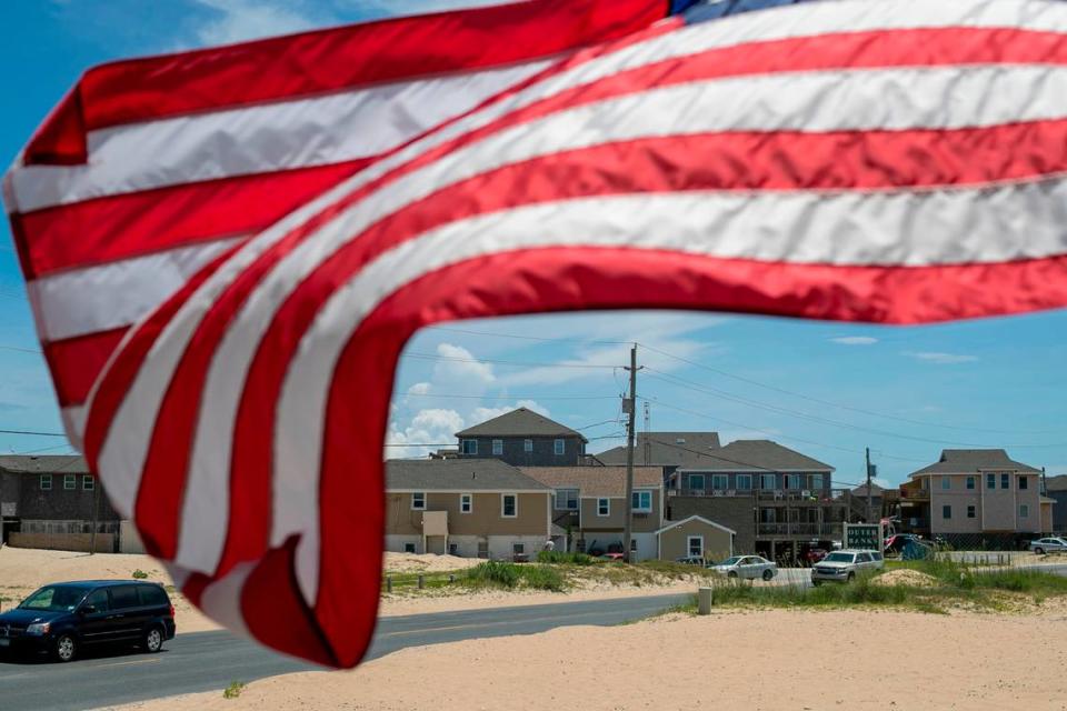 The American Flag is whipped by the wind along NC 12 at the Cape Hatteras Motel on Thursday, July 1, 2021 in Buxton, N.C.
