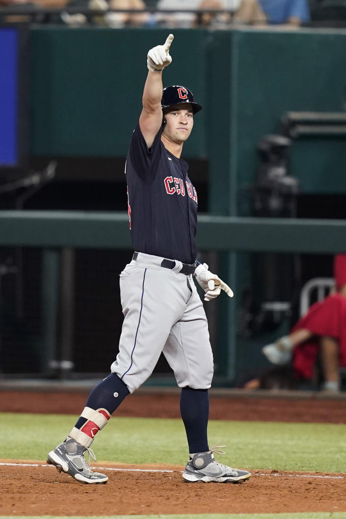 Cleveland Guardians' Will Brennan points to the dugout after hitting in two runs with a single during the sixth inning of a baseball game against the Texas Rangers in Arlington, Texas, Friday, Sept. 23, 2022. Guardians' Andres Gimenez and Oscar Gonzalez scored on the play. (AP Photo/LM Otero)