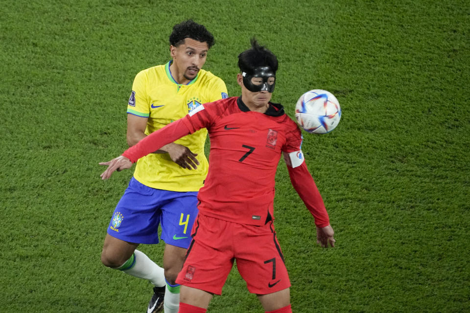 Brazil's Marquinhos, left, and South Korea's Son Heung-min compete for the ball during the World Cup round of 16 soccer match between Brazil and South Korea, at the Education City Stadium in Al Rayyan, Qatar, Monday, Dec. 5, 2022. (AP Photo/Ariel Schalit)
