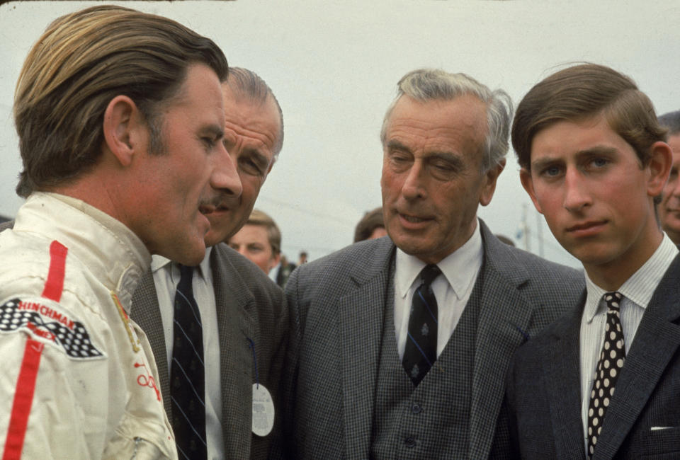 British race car driver Graham Hill talks with Lord Louis Mountbatten (1900 - 1979) and Prince Charles, Prince of Wales. (Photo by Susan Wood/Getty Images)