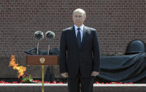 Russian President Vladimir Putin pauses as he delivers his speech standing next to a small group of Russian WWII veterans, during a wreath laying ceremony at the Tomb of Unknown Soldier in Moscow, Russia, Tuesday, June 22, 2021, marking the 80th anniversary of the Nazi invasion of the Soviet Union. (Alexei Nikolsky, Sputnik, Kremlin Pool Photo via AP)