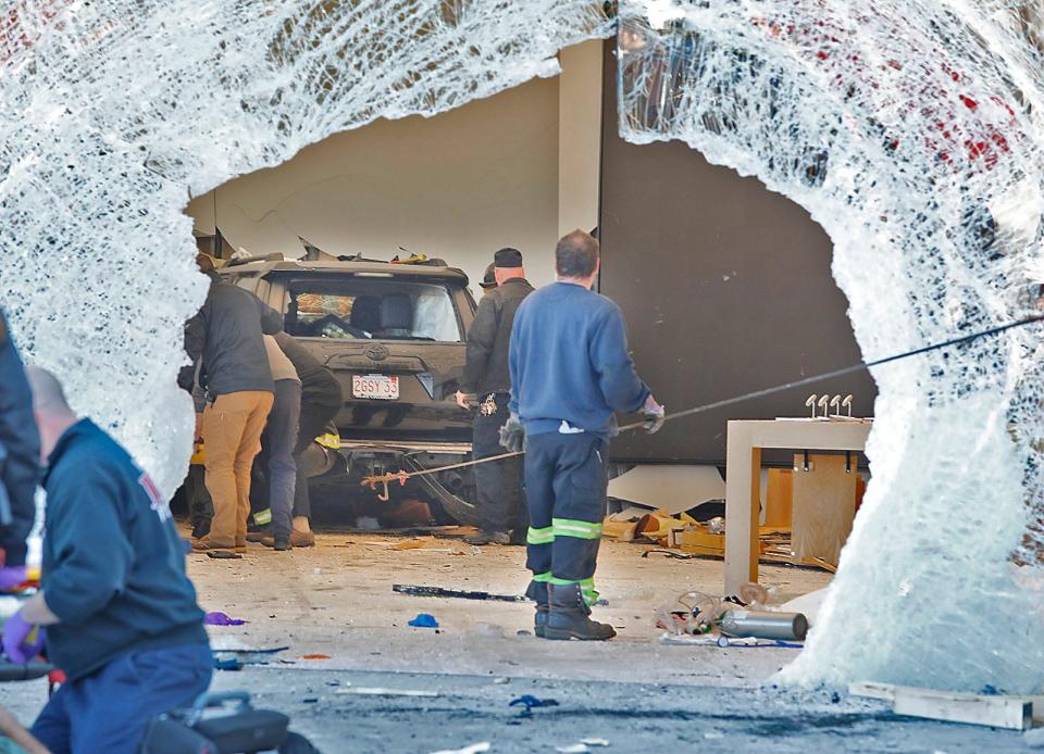 A crash left a gaping hole in the Apple Store storefront in Hingham, Mass., on Monday, Nov. 21, 2022.