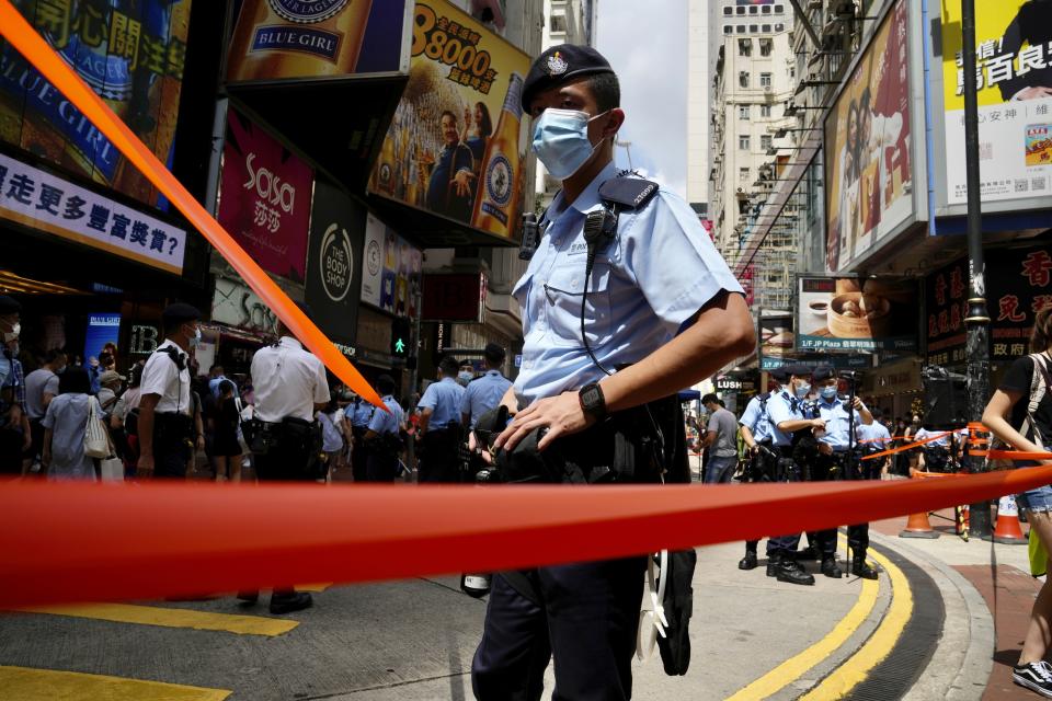 Police officers stand guard near Victoria Park, a past location for the annual protest rally marking the anniversary of the Hong Kong handover to China from Britain in Hong Kong, Thursday, July 1, 2021. (AP Photo/Kin Cheung)