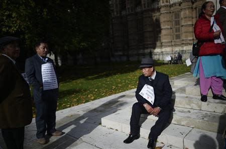 A retired Gurkha soldier sits down during a demonstration outside the Palace of Westminster in London October 25, 2013. REUTERS/Dylan Martinez