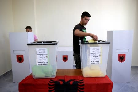 A man casts his ballot at a polling station near Tirana