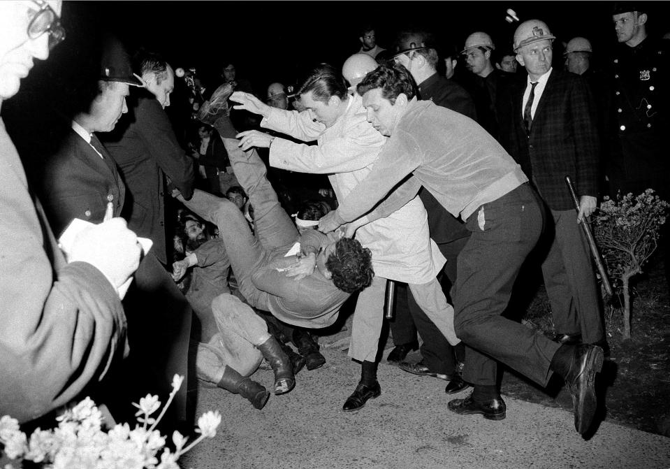 FILE - New York City plainclothes policemen drop a student protester on the ground after he and others holding a sit-in at Columbia University building were removed, April 30, 1968. (AP Photo/File)