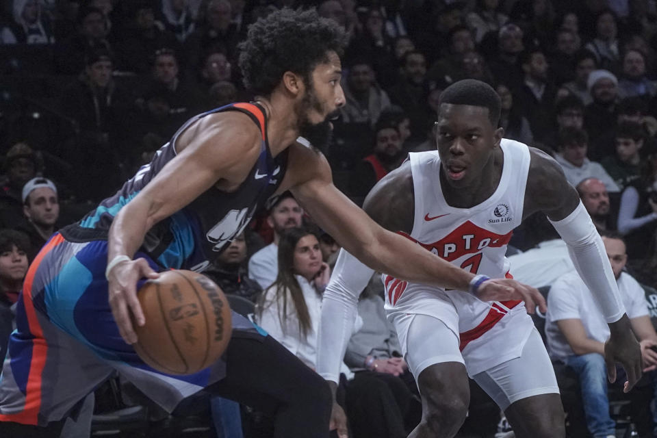 Brooklyn Nets' Spencer Dinwiddie, left, handles the ball against Toronto Raptors' guard Dennis Schroder during an NBA In-Season Tournament basketball game, Tuesday, Nov. 28, 2023, in New York. (AP Photo/Bebeto Matthews)