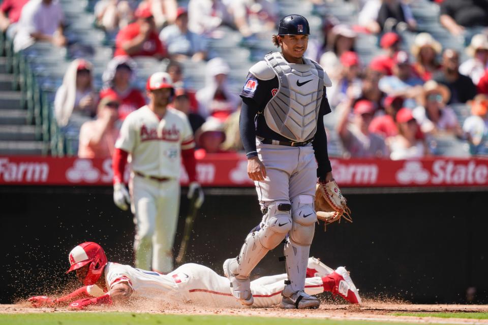 Cleveland Guardians catcher Bo Naylor stands as Los Angeles Angels' Kyren Paris slides home off a grounder hit by Randal Grichuck, who was out at first, during the third inning of a baseball game, Sunday, Sept. 10, 2023, in Anaheim, Calif. (AP Photo/Ryan Sun)