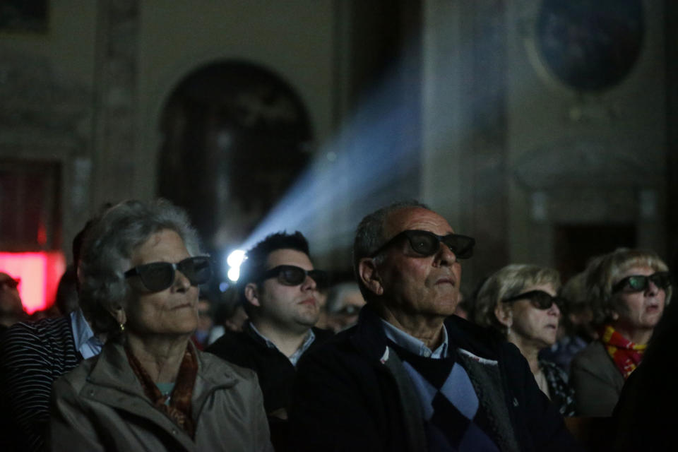 Faithful wear 3D glasses as they watch the screening of the canonization of Pope John XXIII and Pope John Paul II taking place at the Vatican, at the parish church in Sotto il Monte Giovanni XXIII, near Bergamo, northern Italy, the town of John XXIII, Sunday, April 27, 2014. Pope Francis declared his two predecessors John XXIII and John Paul II saints on Sunday before hundreds of thousands of people in St. Peter's Square, an unprecedented ceremony made even more historic by the presence of retired Pope Benedict XVI. (AP Photo/Luca Bruno)