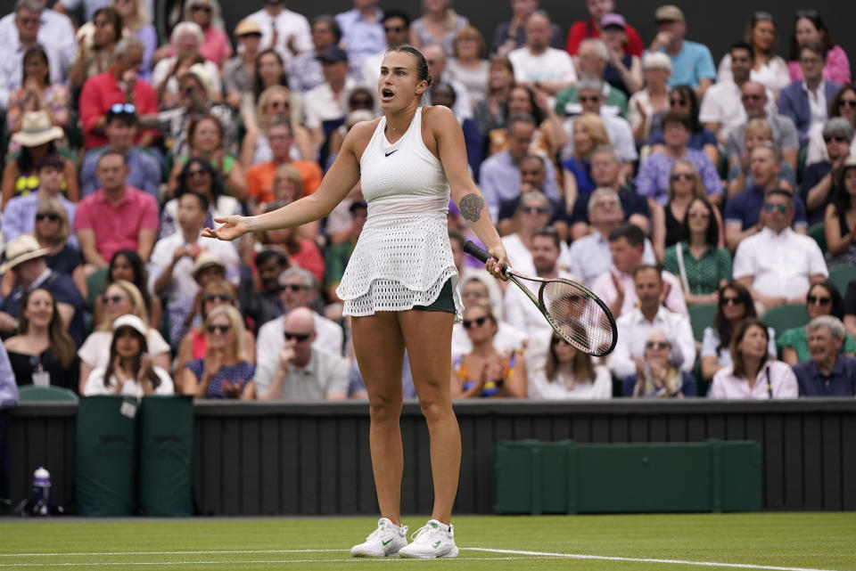 FILE - Aryna Sabalenka of Belarus reacts as she plays Tunisia's Ons Jabeur in a women's singles semifinal match on day eleven of the Wimbledon tennis championships in London, Thursday, July 13, 2023. A year out from the Paris Olympics, and nearly a year and a half since Russia's full-scale invasion of Ukraine, officials governing the many sports on the Olympic program are still split on how to treat Russian athletes. (AP Photo/Alberto Pezzali, File)