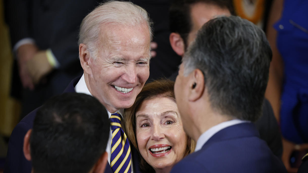 President Biden gathers with Speaker of the House Nancy Pelosi and Rep. Mark Takano after signing the PACT Act on Aug. 1. 