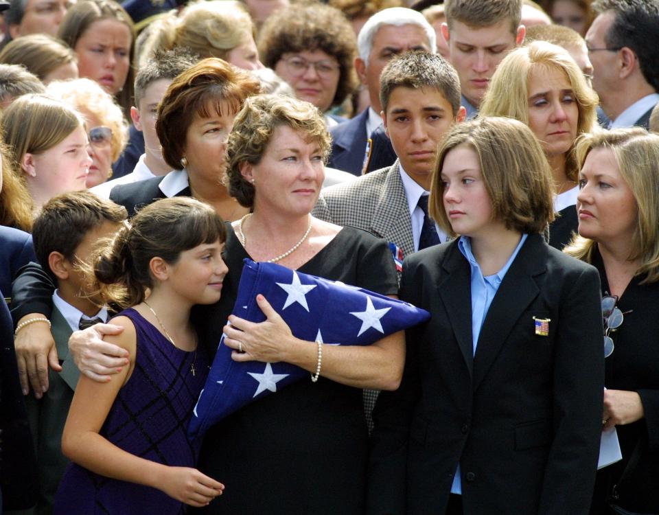 Ellen Saracini and daughters Brielle and Kirsten at memorial mass in 2001 (AFP via Getty Images)