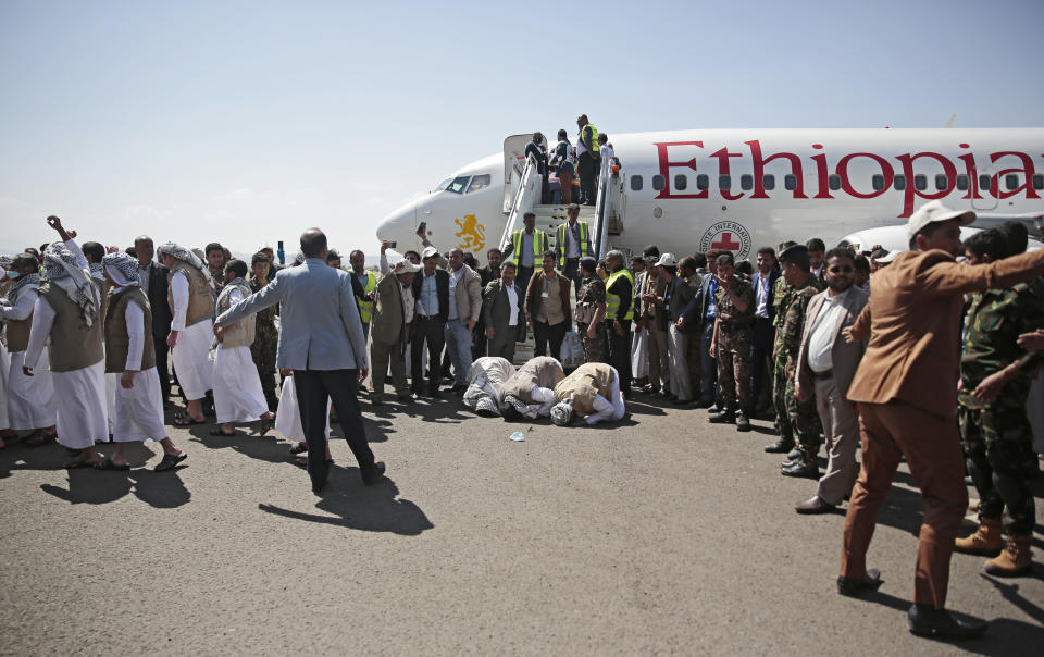 Yemeni prisoners pray during their arrival after being released by the Saudi-led coalition at the airport in Sanaa, Yemen, Thursday, Oct. 15, 2020. (AP Photo/Hani Mohammed)