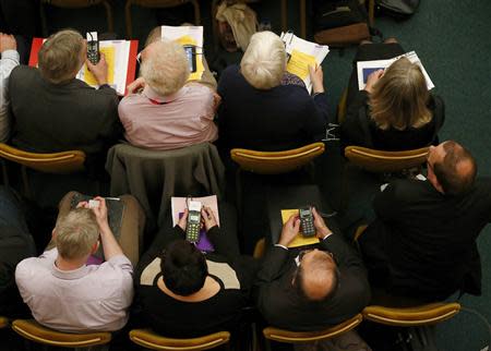 A member of The Church of England's General Synod prepares to vote at Church House in central London November 20, 2013. REUTERS/Andrew Winning