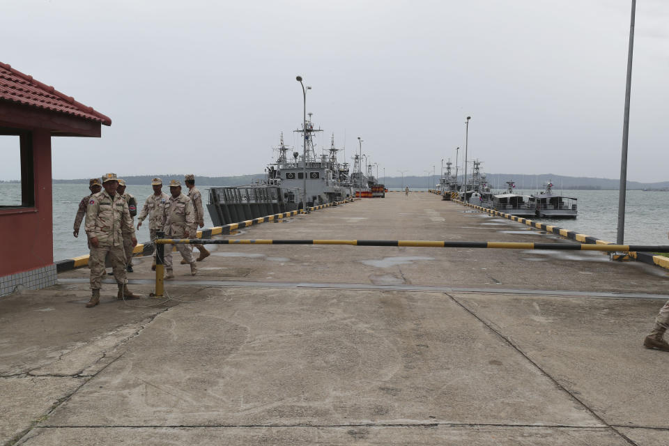 FILE - Cambodian navy troop members walk on the pier at Ream Naval Base in Sihanoukville, southwestern of Phnom Penh, Cambodia on July 26, 2019. Cambodian officials broke ground Wednesday, June 8, 2022, on a naval port expansion project in Ream, dismissing American concerns it could provide Beijing with a strategically important outpost on the Gulf of Thailand. (AP Photo/Heng Sinith, File)