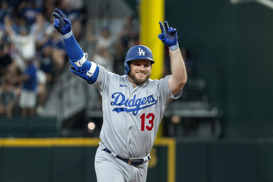 Los Angeles Dodgers' Max Muncy celebrates as he rounds second base on a solo home run off Texas Rangers starting pitcher Dane Dunning during the third inning of a baseball game Saturday, July 22, 2023, in Arlington, Texas.(AP Photo/Jeffrey McWhorter)