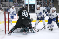 Toronto Maple Leafs center John Tavares, right, scores a goal past San Jose Sharks goaltender James Reimer and defenseman Brent Burns (88) during the second period of an NHL hockey game Friday, Nov. 26, 2021, in San Jose, Calif. (AP Photo/Tony Avelar)