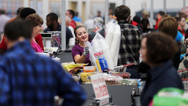 Betty Fletes helps customers through the checkout area of the world’s largest Costco, located in Salt Lake City, in 2015.