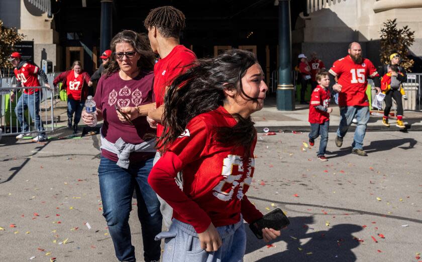 TOPSHOT - People flee after shots were fired near the Kansas City Chiefs' Super Bowl LVIII victory parade on February 14, 2024, in Kansas City, Missouri. A shooting incident at a packed parade Wednesday to celebrate the Kansas City Chiefs' Super Bowl victory killed one person and injured 21 others, police said. (Photo by ANDREW CABALLERO-REYNOLDS / AFP) (Photo by ANDREW CABALLERO-REYNOLDS/AFP via Getty Images)