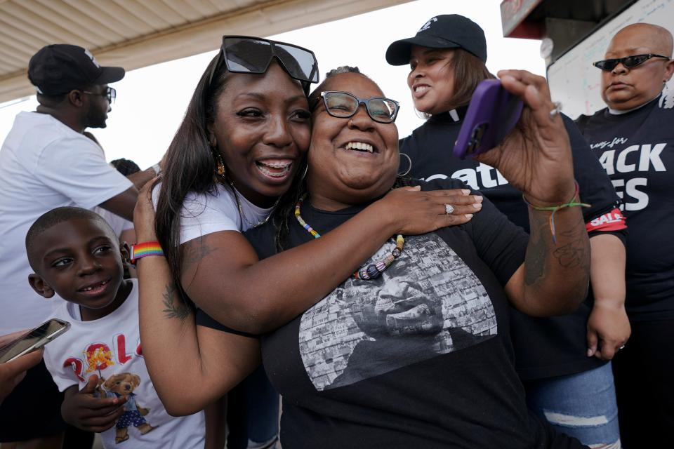 Jennifer Starr Dodd, right, is embraced by Nikki Johnson as her son, 6-year-old Brandon Johnson looks on, after a sentence of 22 1/2 years is announced for former Minneapolis police officer Derek Chauvin in the murder of George Floyd, Friday, June 25, 2021, at George Floyd Square where Floyd was killed, in Minneapolis.