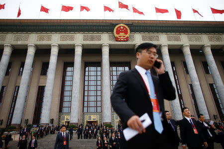 Delegates leave the Great Hall of the People in Beijing, one day before the start of 19th National Congress of the Communist Party of China, October 17, 2017. REUTERS/Thomas Peter