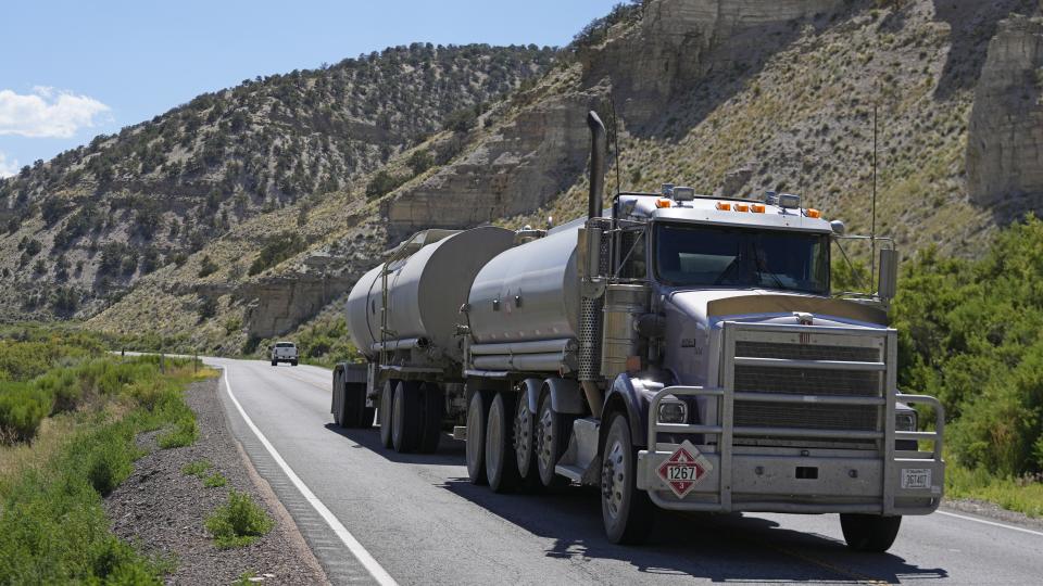 A tanker truck transports oil through the Uinta Basin basin south of Duchesne, Utah on Thursday, July 13, 2023. Local politicians and oil and gas businesses want to construct a multi-billion dollar railroad to transport more barrels out of remote eastern Utah but face safety, environmental and cost concerns. (AP Photo/Rick Bowmer)