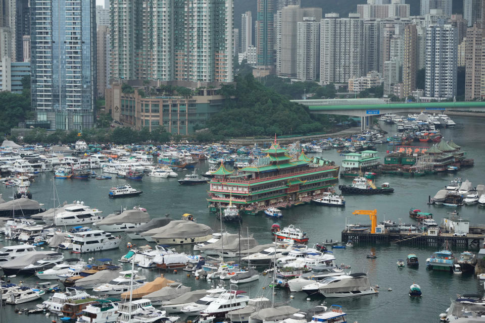 Hong Kong's iconic Jumbo Floating Restaurant is towed away in Hong Kong, Tuesday, June 14, 2022. Hong Kong's iconic restaurant on Tuesday departed the city, after its parent company failed to find a new owner and lacked funds to maintain the establishment amid months of COVID-19 restrictions. (AP Photo/Kin Cheung)