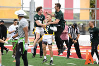 <p>Aaron Rodgers gets some air time with members of his flag football team at his <a href="https://people.com/parents/josh-duhamel-finally-enjoying-sports-exclusive/" rel="nofollow noopener" target="_blank" data-ylk="slk:RX3 charity flag football tournament;elm:context_link;itc:0;sec:content-canvas" class="link ">RX3 charity flag football tournament</a> in Newport Beach, Calif. Rodgers and other celebrity players raised more than $1.5 million for charities including The Boys and Girls Club. </p>