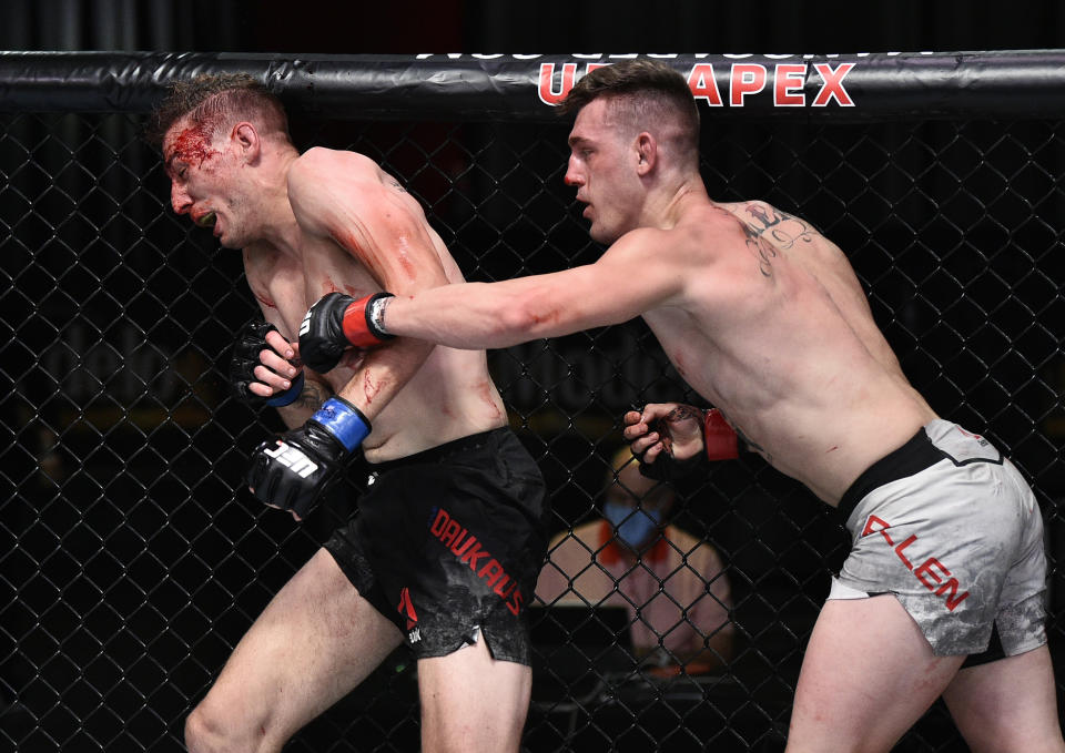 Brendan Allen punches Kyle Daukaus in the octagon.